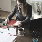 woman in gray long sleeve shirt sitting at the table